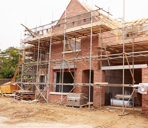 scaffolding structure with a blue map of the United Kingdom construction industry progress and development